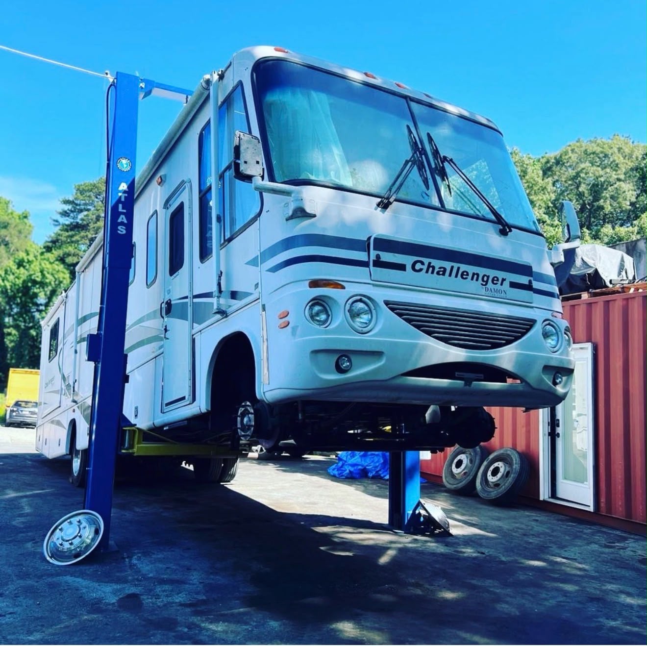 Class A motorhome on the shop lift